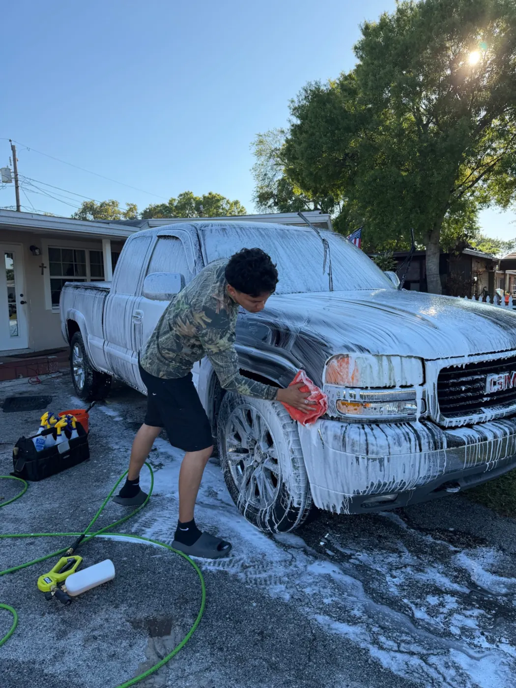 Kevin washing a customer's GMC truck on site