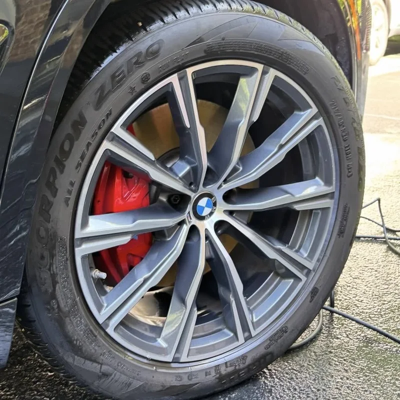 Same BMW wheel after cleaning, with dressed tire
